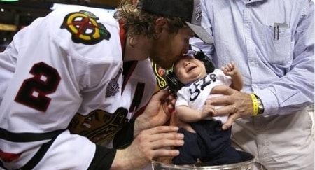 Duncan Keith kissing his son Colton Keith